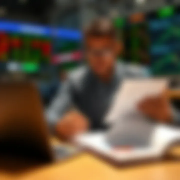 South African trader reviewing financial documents with a laptop and charts